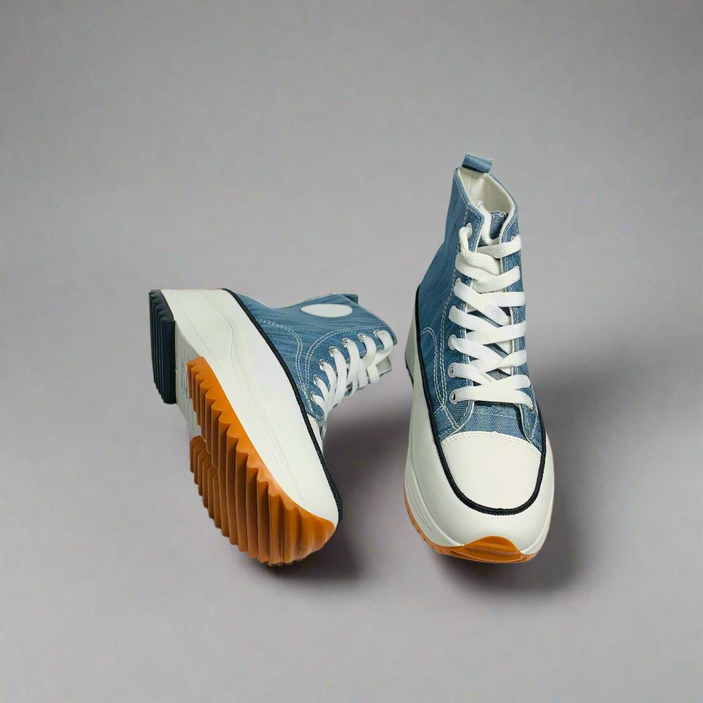 High-Top sneaker with a Blue textured canvas upper, The shoe Features a chunky white sole with a brown rubber sole.