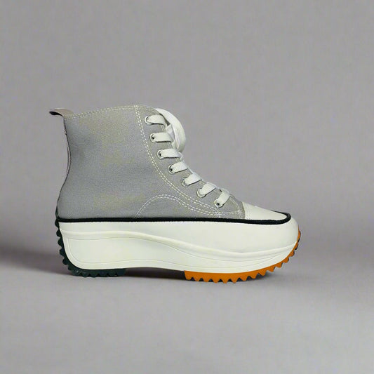 High-Top sneaker with a rey canvas upper, The shoe Features a chunky white sole with a brown rubber sole.