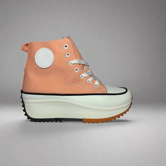 High-Top sneaker with a pink canvas upper, The shoe Features a chunky white sole with a brown rubber sole.