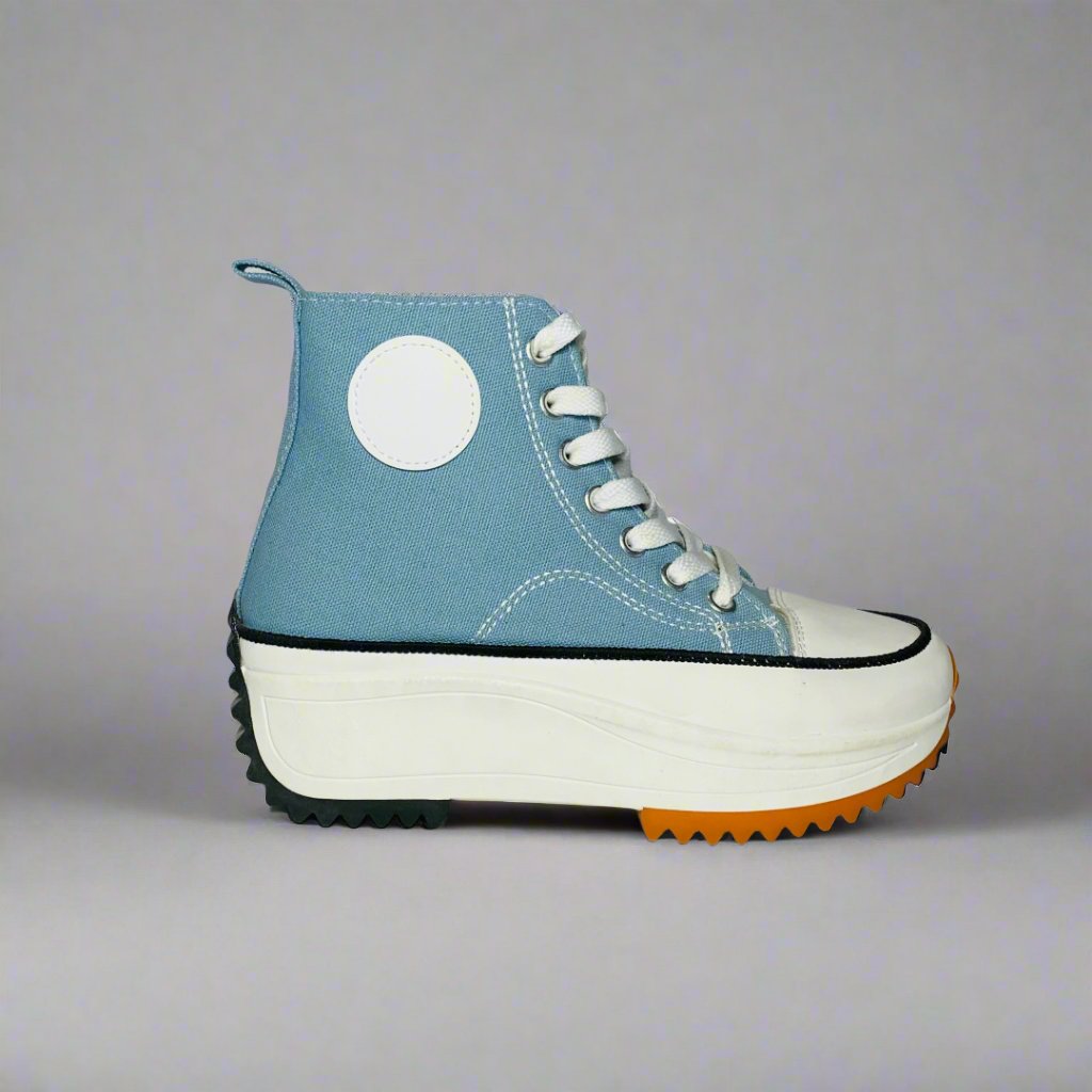 High-Top sneaker with a Blue canvas upper, The shoe Features a chunky white sole with a brown rubber sole.