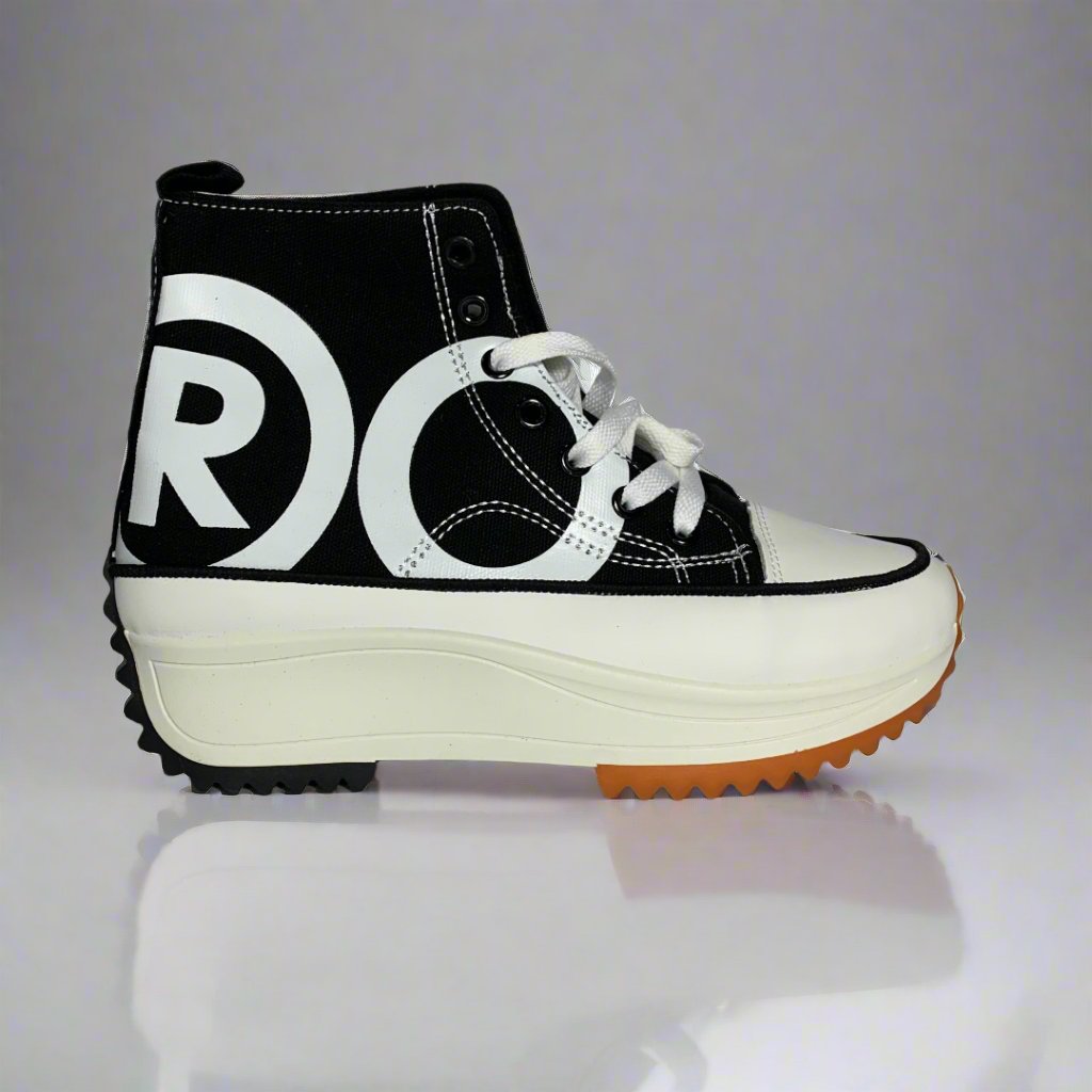 High-Top sneaker with a contrasting Black and white pattern on the canvas upper, The shoe Features a chunky white sole with a brown rubber sole.