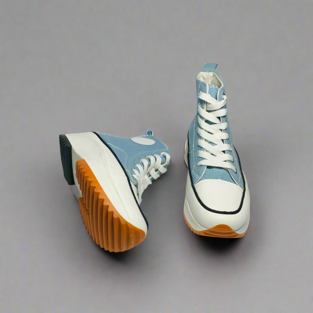 High-Top sneaker with a Blue canvas upper, The shoe Features a chunky white sole with a brown rubber sole.